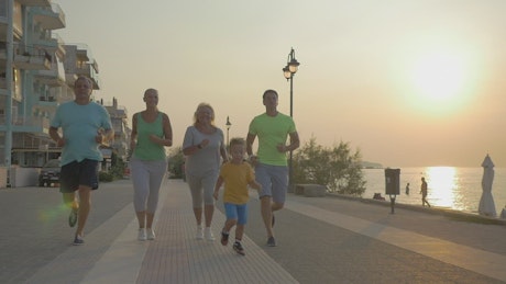 Family running by the waterfront
