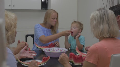 Family sharing a watermelon