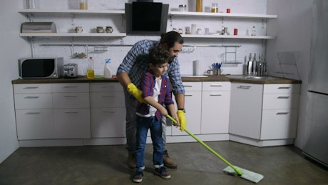 Father and son cleaning their house.