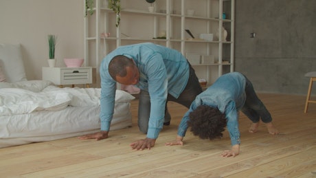 Father and son doing push-ups together.