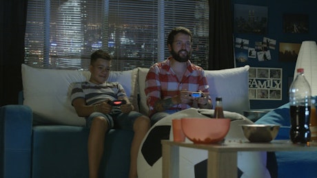 Father and son playing video games.