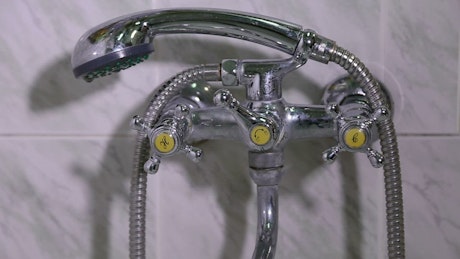 Faucet of a bath and shower dripping.
