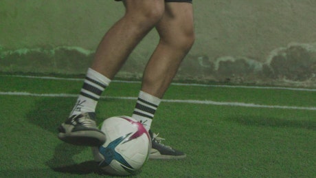 Feet of a skillful soccer player dribbling.