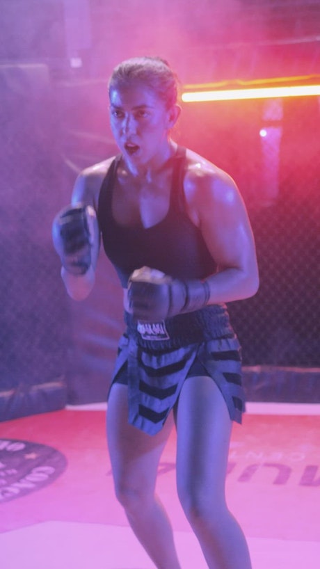 Female fighter preparing for a match in a ring.