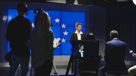 Female news presenter on TV studio.