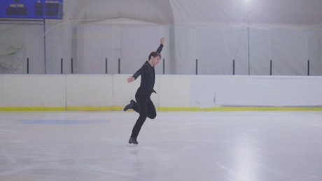 Figure skater performing figure skating routine.