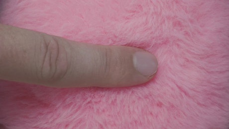Finger slide over pink fur