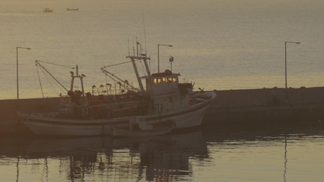 Fishing boat anchored in a harbor town.