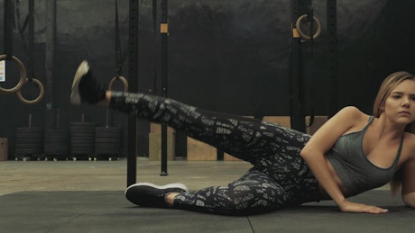 Fitness woman warming up at a gym.