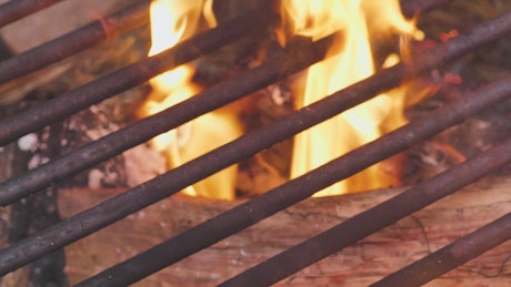 Flames burning inside a grill.
