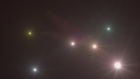 Flickering spotlights on black background