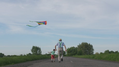 Flying a kite with his Grandpa.