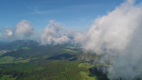 Flying at cloud level with the mountains below