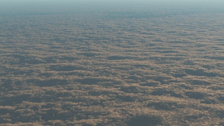 Flying over a layer of small clouds.