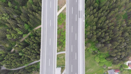 Flying over an elevated highway in the countryside.