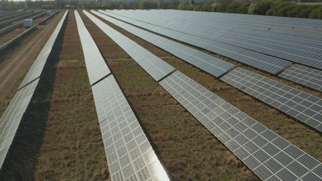 Flying over long rows of solar panels.