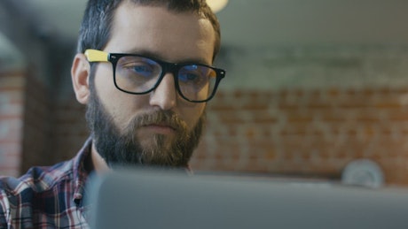 Focused man watching at computer.