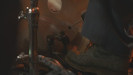Foot of a drummer playing the bass drum with the pedal.