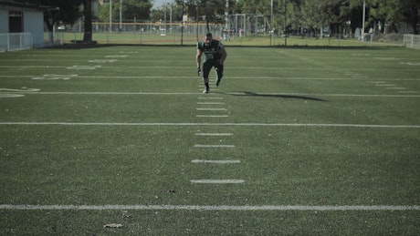 Football player running to the camera.