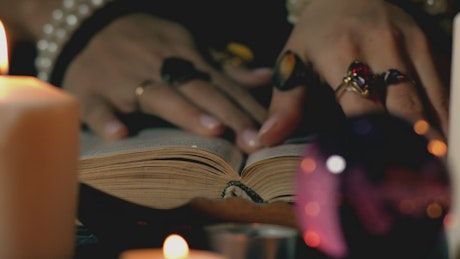 Fortune teller reading an ancient book