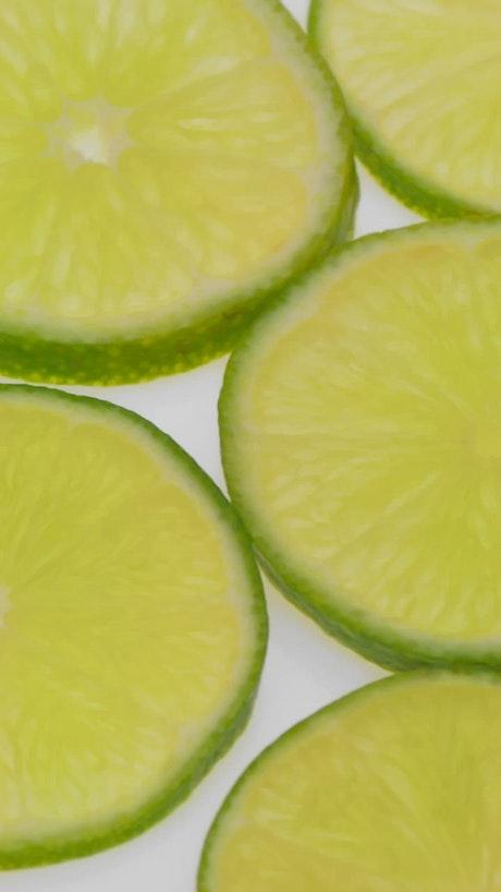 Fresh lemon slices over a bright background.