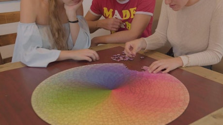Friends forming a big circular puzzle.