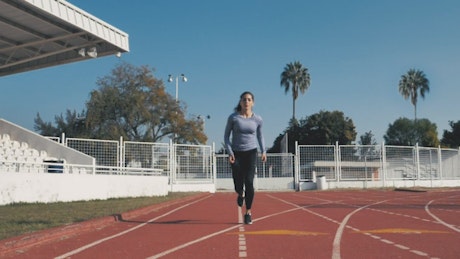 Front view of a woman running.