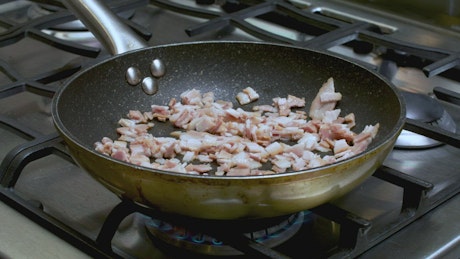 Frying Bacon Chunks on the Stove.