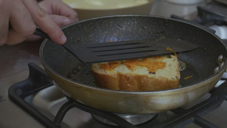 Frying bread with butter for a dessert.