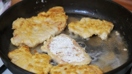 Frying pan cooking meat cutlets