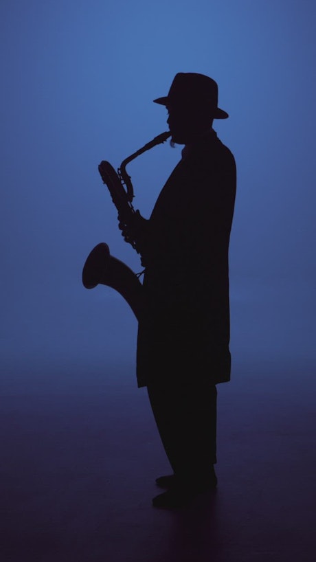 Full body silhouette of a saxophonist.