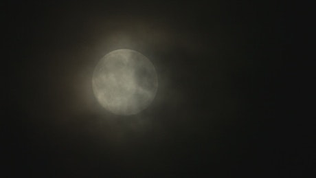 Full moon with a soft haze.