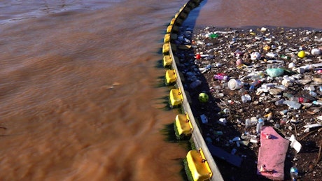 Garbage polluting the water of a lake.