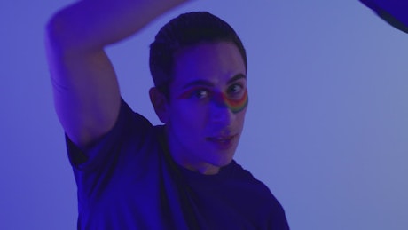 Gay man playing with LGBT pride flag.