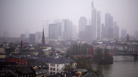 German city with fog while snowing.