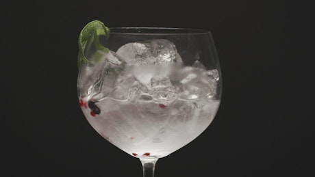 Gin with ice and lime, close up.
