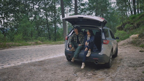 Girl and boy enjoying nature during a road trip.