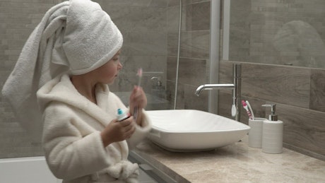Girl applying toothpaste