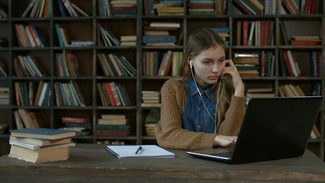 Girl doing homework in a library