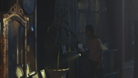 Girl exploring a haunted mansion at night.