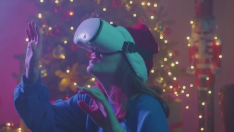 Girl having fun with VR glasses during christmas time.