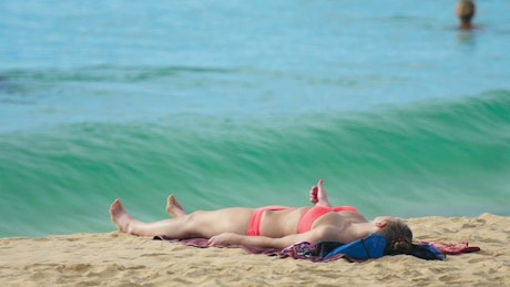 Girl in bikini laying on the beach