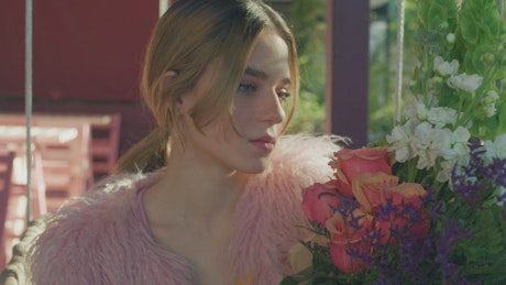 Girl in love smells a bouquet of flowers