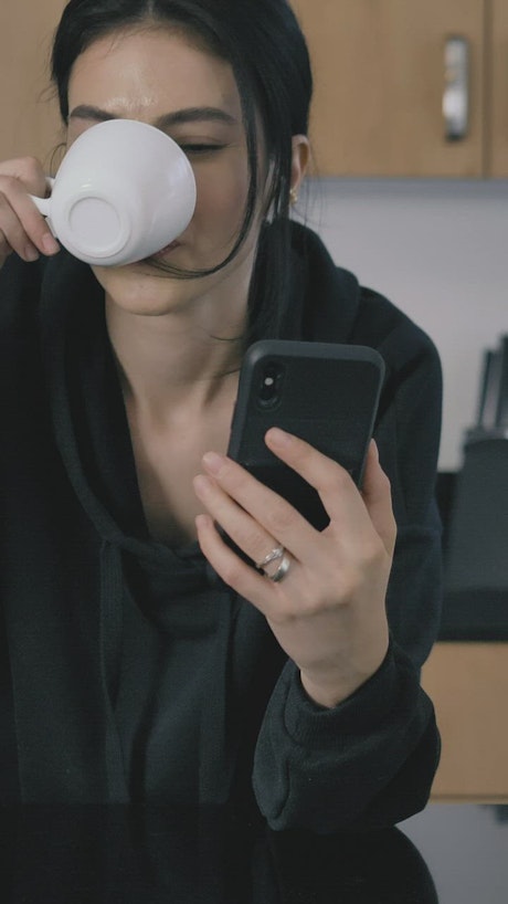 Girl on a video call while drinking coffee.