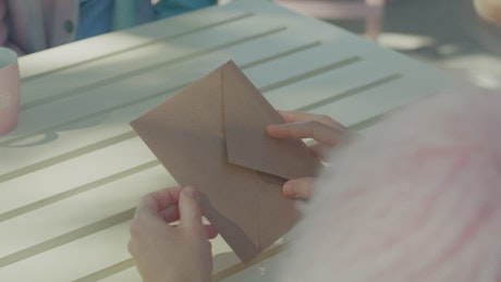 Girl opening an envelope from a Valentine's day card