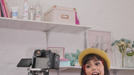 Girl recording a makeup tutorial in a set.