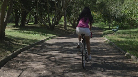Girl riding a bicycle in the park
