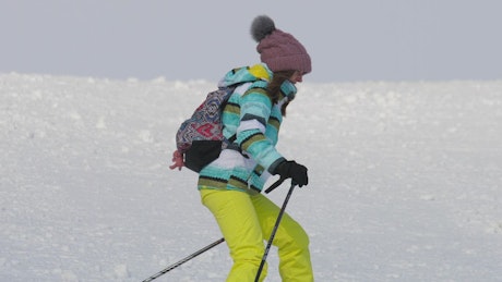 Girl skiing down the hill.