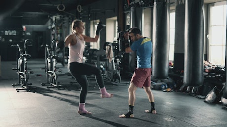 Girl training kickbox with her personal trainer.