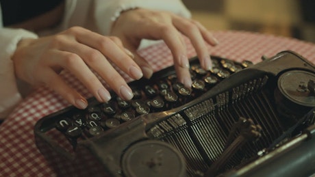 Girl using old typewriter.